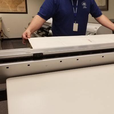 Texas General Land Office staffer operating Contex's HD Ultra X large format scanner